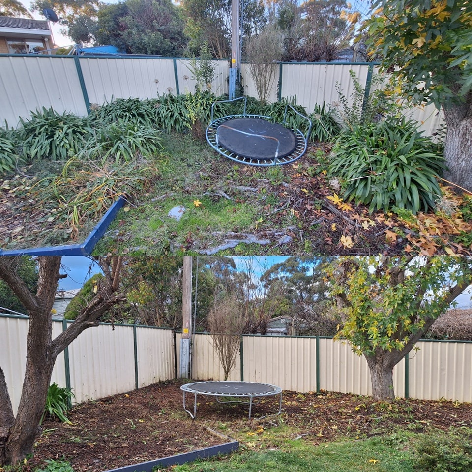 A professional gardener in uniform meticulously mowing a lush green lawn in a Canberra backyard.